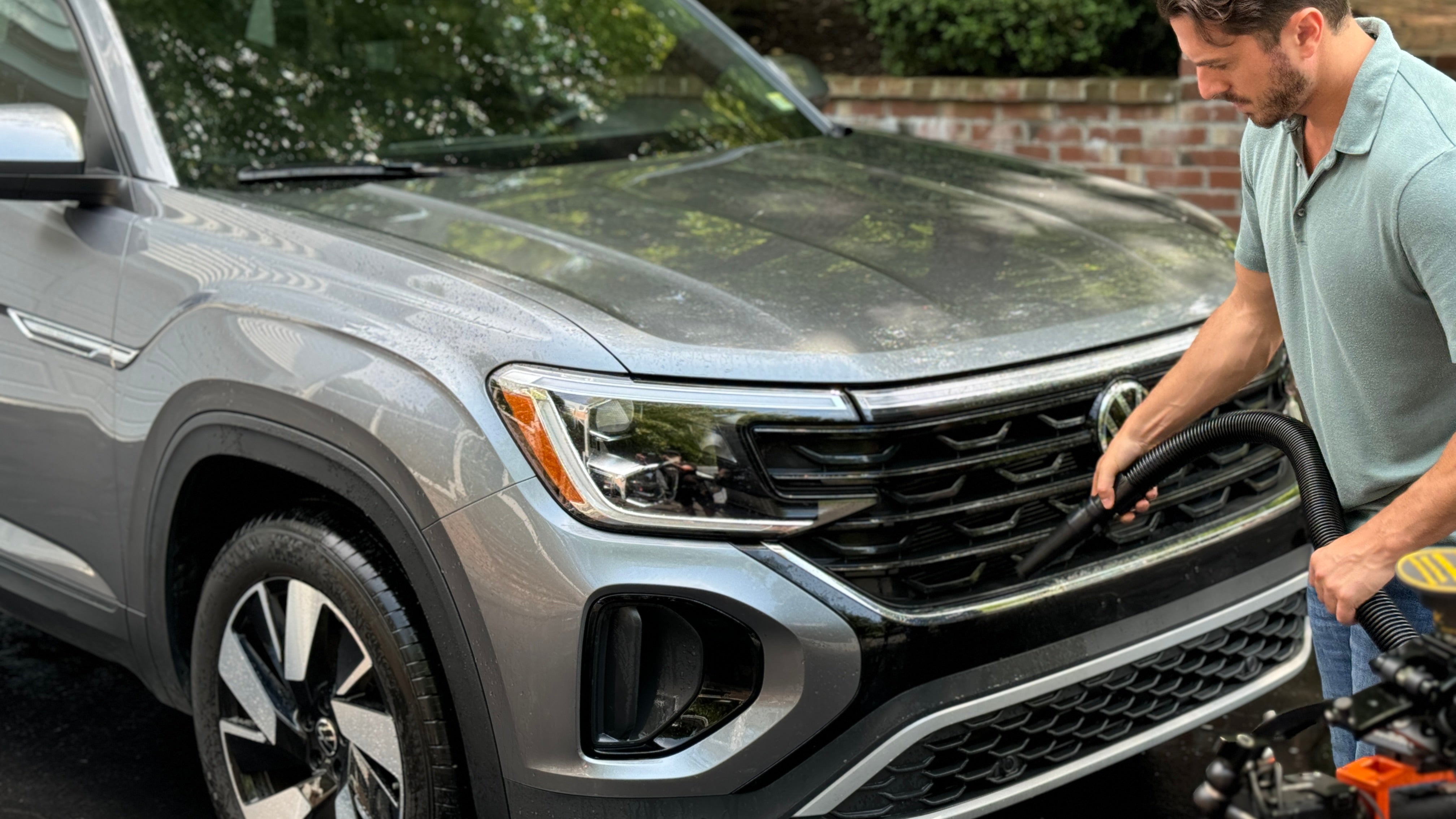 Front grill of a wet SUV being dried with the Master Blaster Car Dryer, perfect example of professional-grade car blow dryer performance.